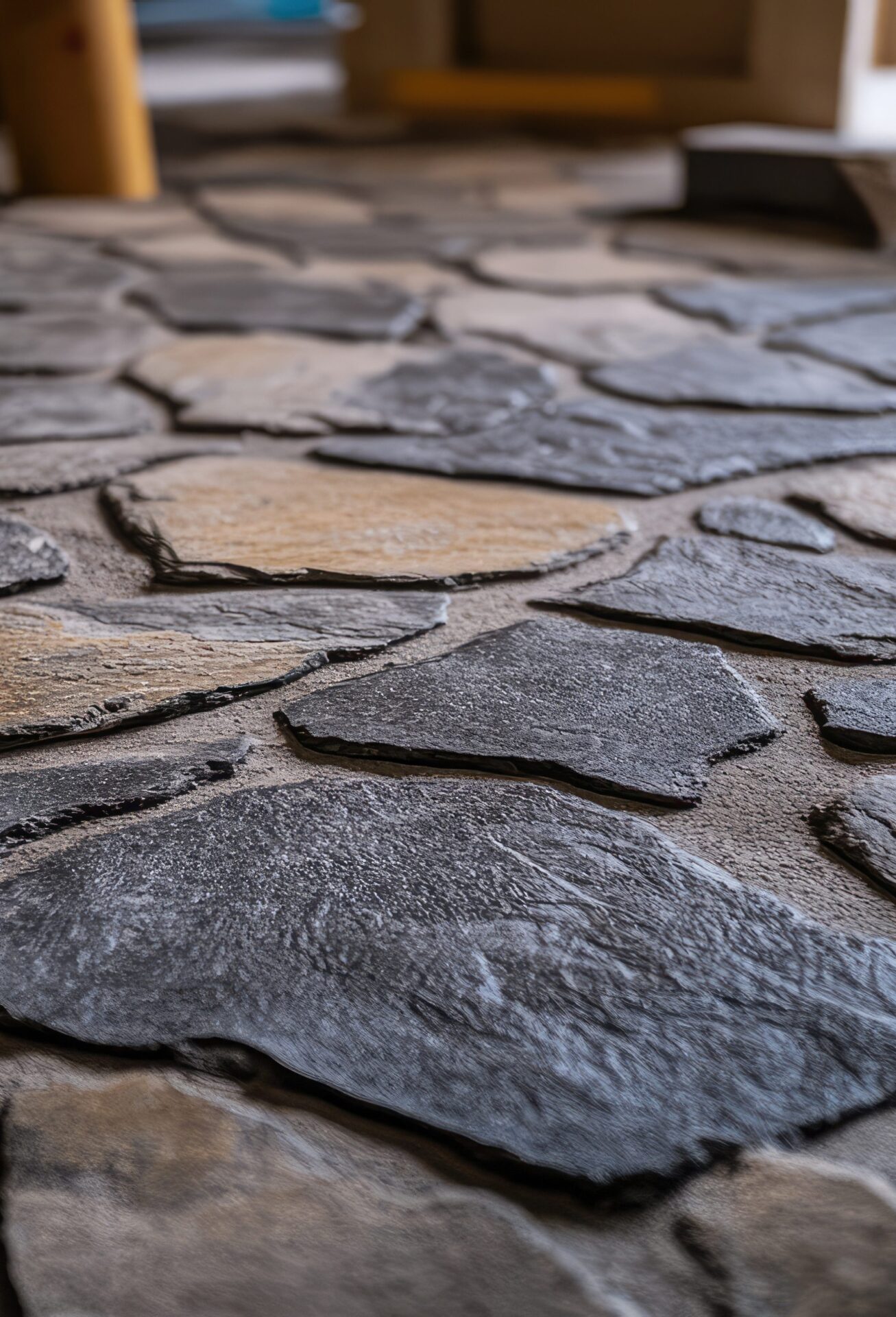 A stone floor with a black and brown tile pattern